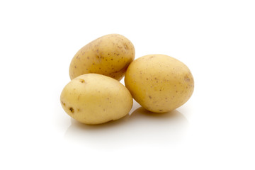 Potatoes on the white background.  New harvest.