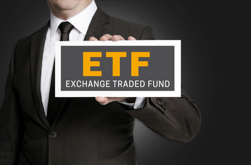 ETF sign is held by businessman