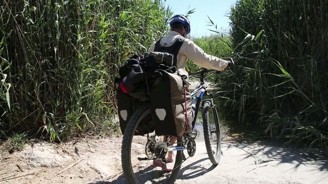 Bicycle touring through the countryside, crossing a brook