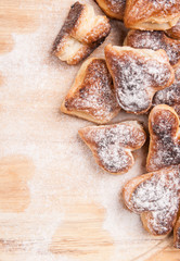bakery hearts from split pastry with sugar powder on wooden