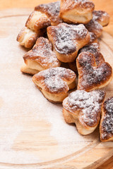 bakery hearts from split pastry with sugar powder on wooden