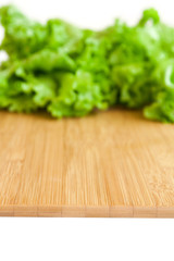 background with wooden board and leaf lettuce