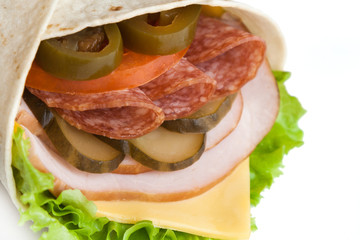 hot roll from lavash with sliced sausage and jalapeno