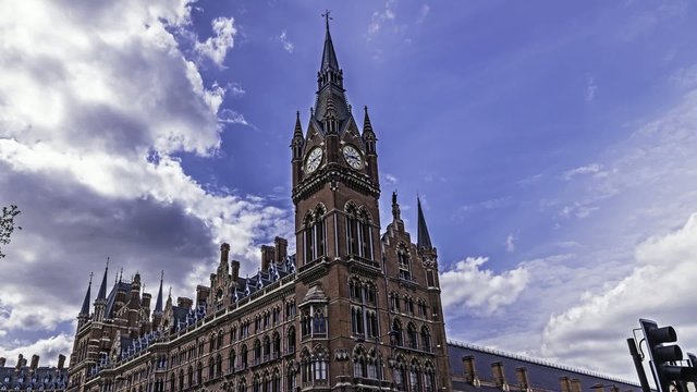 Timelapse view of the Victorian neo-gothic facade of St Pancras station in London. St Pancras is the only international train station in London