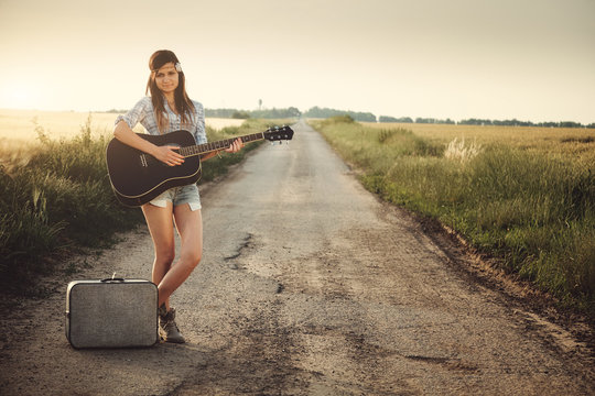 Traveler hippie girl with guitar