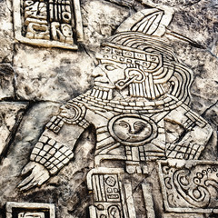 Ancient Mayan hieroglyphics in stone, from the ruins