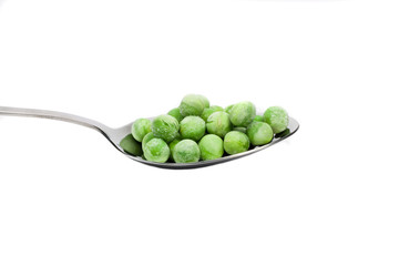 fresh frozen green peas on spoon