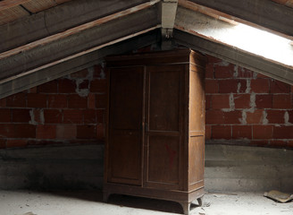 wooden wardrobe in the dusty uninhabited attic - obrazy, fototapety, plakaty