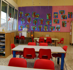 classroom of a kindergarten with red chairs