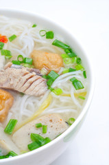 Bun cha ca or Vietnamese rice vermicelli with grilled fish and herbs on a white background