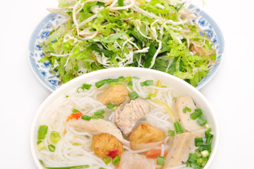 Bun cha ca or Vietnamese rice vermicelli with grilled fish and herbs on a white background