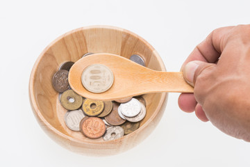 Japan coin in wooden bowl on white background