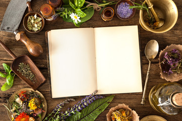 Ancient natural medicine, herbal, vials and recipe book on wooden background
