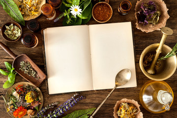 Fototapeta Ancient natural medicine, herbal, vials and recipe book on wooden background obraz