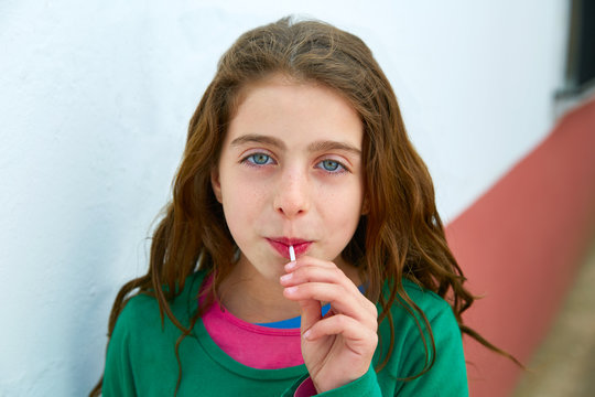 Beautiful Blue Eyes Kid Gils Eating Lollipop Sweet