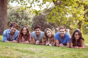 Friends lying and talking in the park