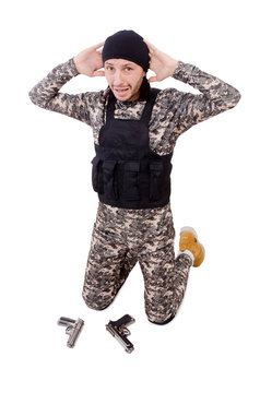 Surrendering man in military uniform holding gun isolated on
