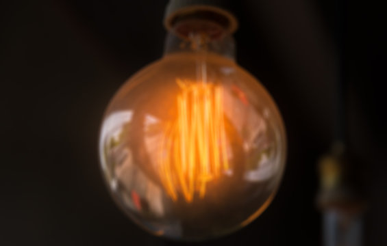 Blur of orange lamp in dark room