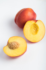 Nectarines - cut in half over white background