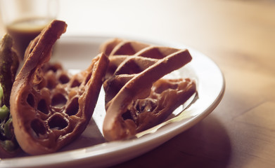 Chocolate Waffle  on white plate closeup in vintage tone