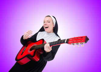 Nun playing guitar against the gradient 