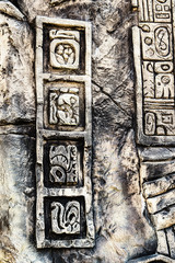 Ancient Mayan hieroglyphics in stone, from the ruins