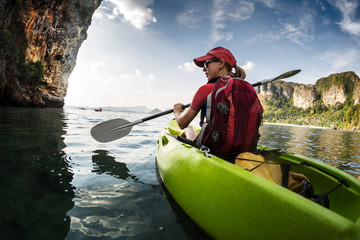 Young lady paddling kayak
