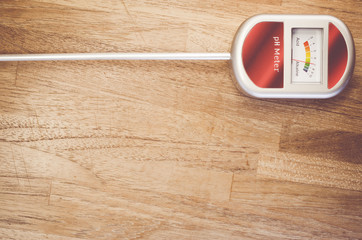 analog soil ph meter on a wood surface