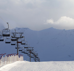 Snow skiing piste and ropeway at evening