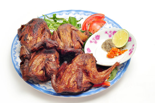 Vietnamese grilled quail on a white background