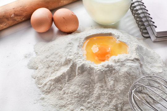 making dough with egg , flour and milk