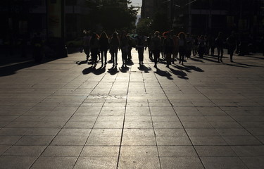 Shadows of people walking in a street of the city, Athens
