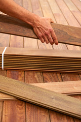 Ipe deck installation carpenter hands holding wood