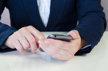 hand with mobile ..typing message into mobile