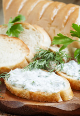 Bruschetta with white sauce and herbs, selective focus