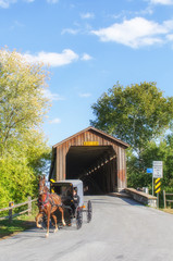 Amish Horse and Buggy Riding Under the Covered Bridge