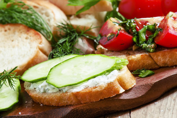 Two types of sandwiches: tomato and cucumber, selective focus