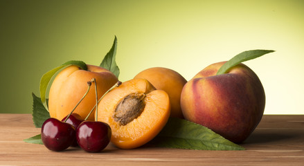 apricots and cherries on the wooden table