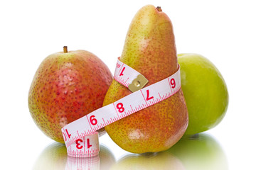 Apple and pear with measuring tape