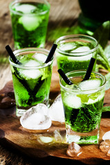 Green cocktail with tarragon, mint soda and ice, selective focus