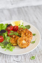 chicken cutlet with fresh vegetable salad in a vintage pan 