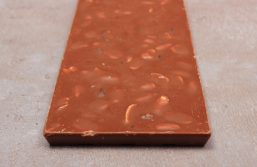 Chocolate with nuts and raisins on cement structure