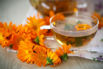 Fototapeta na wymiar Herbal tea with marigold flowers