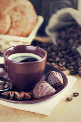 Cup coffee with beans and chocolate candies