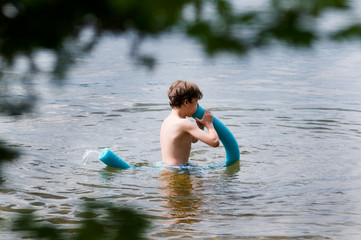 young boy playing with a floating toy