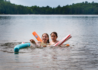 brother and sister playing in a lake