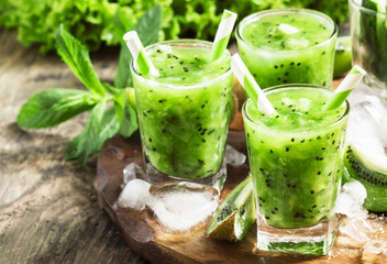 Fresh green juice with kiwi and ice, selective focus