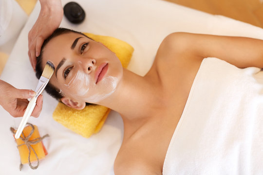 Face Treatment. Woman in Beauty Salon Gets Marine Mask