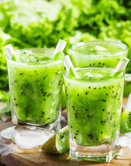 Fresh green juice with kiwi and ice, selective focus