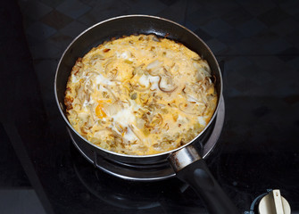 Omelette with fried eggs, sprouts and onions